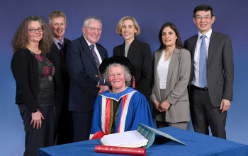 Dr Zoe Hudson (seated) with other speakers from the Night of Science and Engineering - from left to right: Prof Karin Hing, Prof Martin Knight, Lord Tim Clement-Jones (Chair of Council), Dr Alix Pryde, Marium Qaiser, Prof Wen Wang (Vice Principal)